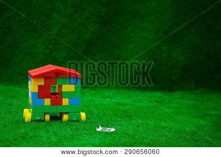 The house of the cubes stands on green grass.