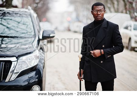 Stylish African American Gentleman In Elegant Black Jacket, Holding Retro Walking Stick As Cane Flas