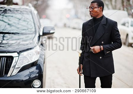 Stylish African American Gentleman In Elegant Black Jacket, Holding Retro Walking Stick As Cane Flas