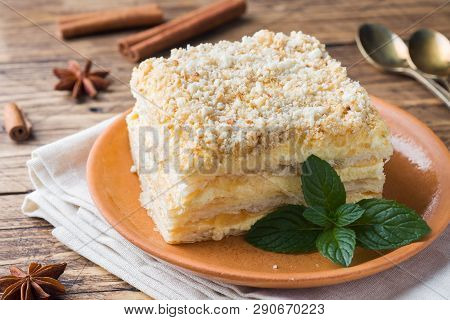 Layered Cake With Cream Napoleon Millefeuille Vanilla Slice With Mint On Wooden Background.