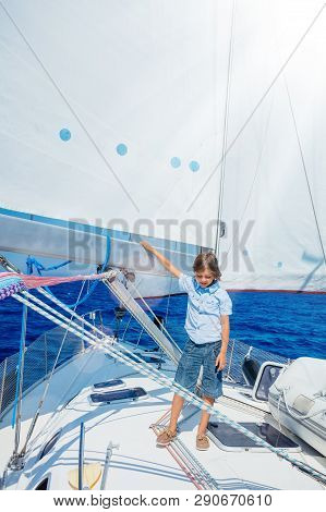 Little Boy On Board Of Sailing Yacht On Summer Cruise. Travel Adventure, Yachting With Child On Fami