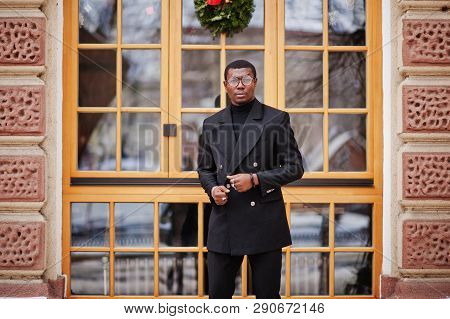 Stylish African American Gentleman In Elegant Black Jacket. Rich Fashionable Afro Man Against Window
