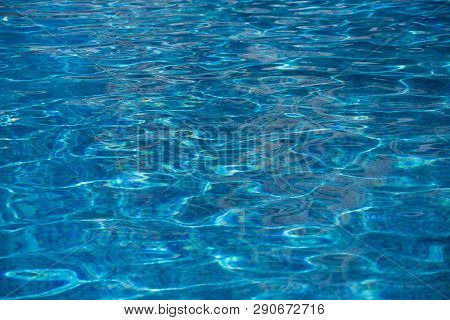 Blurred Water Texture In Summer Pool Close Up.