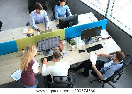 Top View Of Young Modern Colleagues In Smart Casual Wear Working Together While Spending Time In The