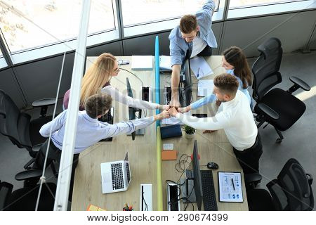 Top View Of Young Modern Colleagues In Smart Casual Wear Working Together While Spending Time In The