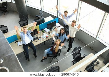 Top View Of Young Modern Colleagues In Smart Casual Wear Working Together While Spending Time In The