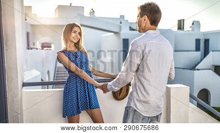 Young Couple In Love, Girl Looks At Man, Hold Hands. Blonde Beautiful Women Smiles Coquettishly. Fir