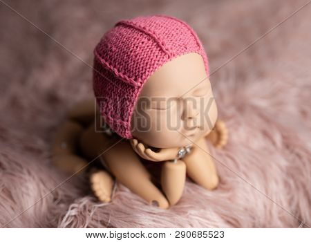 Plastic mannequin of baby, made for posing, in frog stand, isolated