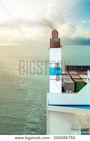 Cargo Ship With A Smoking Pipe Sailing On The Sea