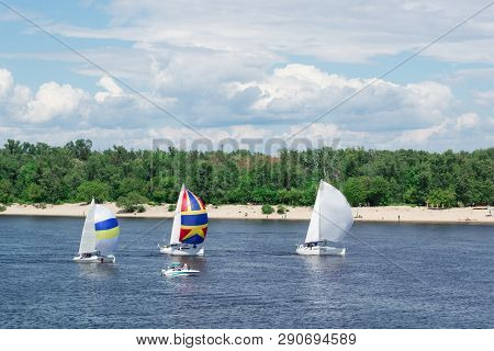 Regatta Competition On Lake River Sailing Yachts Boats With Sails And Multicolored Gennakers, Reflec