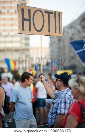 Romania, Bucharest - August 12, 2018: Man Displaying Sign Displaying Thieves Addressed To Government
