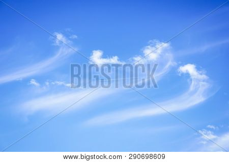 White Clouds On A Blue Sky Background. Clouds Like A Sea Waves