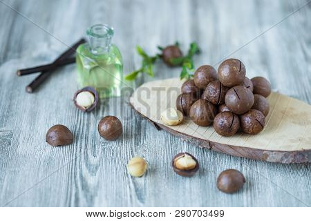 Macadam Nuts, Walnut Oil, On Wooden Background. Relax, Health Care, Body Care