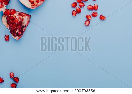 Garnet Background. Ripe Red Garnet Fruit. Garnet Fruit Slices On A Blue Background. Vegetarian Conce