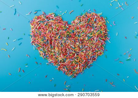 Colorful Confetti On A Blue Background. Place For Text, Copy Space. Abstract Colorful Background. Va