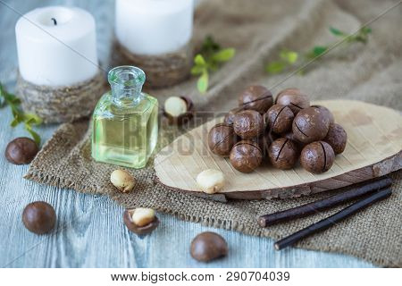 Macadam Nuts, Walnut Oil, On Wooden Background. Relax, Health Care, Body Care