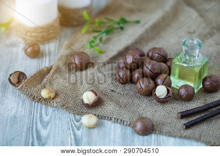 Macadam Nuts, Walnut Oil, On Wooden Background. Relax, Health Care, Body Care
