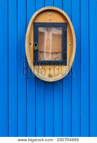The Ancient Wooden Door Painted Blue Color With The Vintage Ornament Located From Outer Side