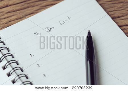Black Pen On What To Do In Personal To Do List Note Pad On Wooden Table Using As Task List, Things T