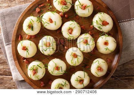 Polish Authentic Kluski Potato Dumplings With Bacon And Green Onions Close-up On A Plate. Horizontal