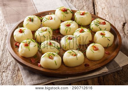 Boiled Potato Dumplings With Fried Bacon And Fresh Green Onions Close-up On A Plate. Horizontal