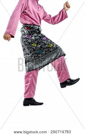 Portrait Of Young And Handsome Asian Man With Traditional Clothing During Hari Raya Over White Backg