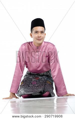 Portrait Of Young And Handsome Asian Man With Traditional Clothing During Hari Raya Over White Backg