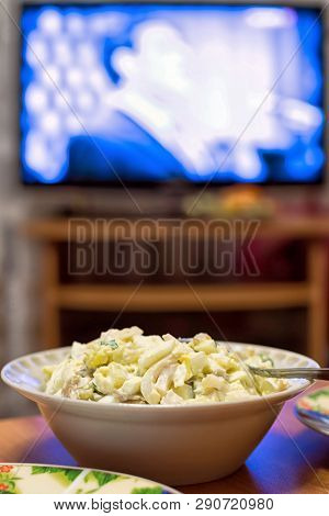 Bowl With Salad With Eggs And Squid With Tv Background On New Year Holiday