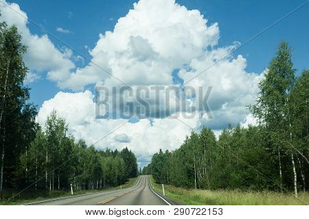 Fields, Trees And Road With Blue Sky And Clouds