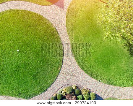 Aerial Drone View Of Backyard Garden With Circle Wath Path, Green Grass Lawn And Trees. Landscape De