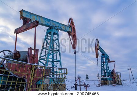 Oil And Gas Industry. Silhouette Oil Pumps On A Sunset Sky Background.oil Industry Equipment. Close 