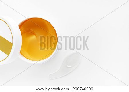 Open Jar With Hydrogel Patches For Eyes. Gold Energy Hydrogel Eye Patch. Top View With Copy Space.