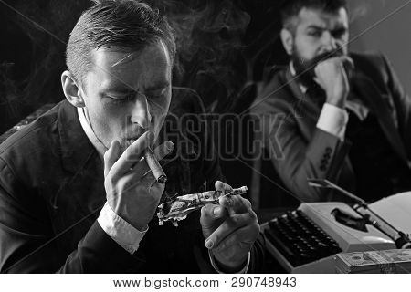 He Is Lousy With Money. Rich Man Smoking During Business Meeting. Man Light Up Cigar From Money Bank