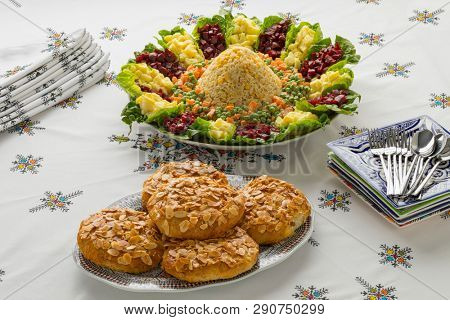 Dish with traditional festive Moroccan mixed salad and mini bastella on a nice set table  