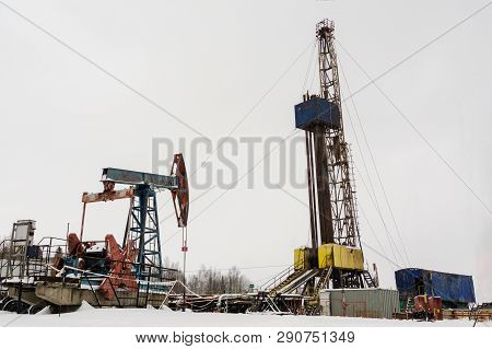 Oil And Gas Drilling Rig Onshore Dessert With Dramatic Cloudscape. Oil Drilling Rig Operation On The