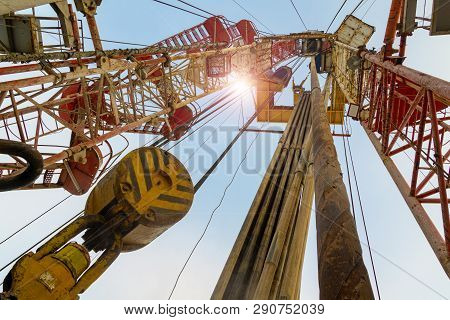 Oil And Gas Drilling Rig Onshore Dessert With Dramatic Cloudscape. Oil Drilling Rig Operation On The