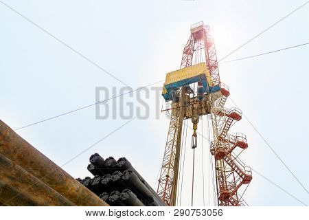 Oil And Gas Drilling Rig Onshore Dessert With Dramatic Cloudscape. Oil Drilling Rig Operation On The