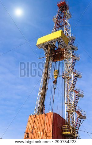 Oil And Gas Drilling Rig Onshore Dessert With Dramatic Cloudscape. Oil Drilling Rig Operation On The