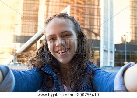 Portrait Photo Of Smiling Happy Teen Girl In A Street,big City