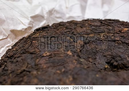 Chinese Pressed Puer Tea On Wrapping Paper, Close-up, Macro