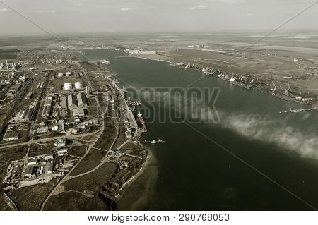 Aerial View Of Panoramic Seaport Warehouse And Container Ship, Crane Vessel Working For Delivery Of