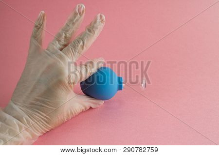 Female Hand With French Manicure In Medicine Glove Holds Blue Cosmetic Medical Jar For Vacuum Facial