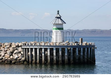 Harbor And Lighthouse Of Ebeltoft In Denmark