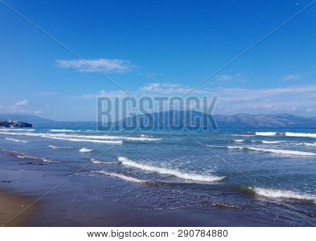 Summer Albania Beach View. Ionian And Adriatic Sea. Seashore With Wave Sand Rock Stone Sky And Sun. 