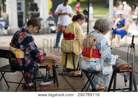 Columbus, Ohio, Usa - May 27, 2018  Three Women Members Of The Columbus Koto Ensemble Play The Koto 