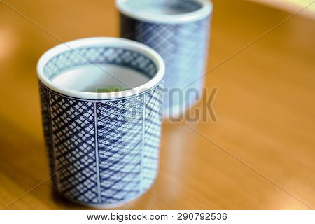 Japanese Tea Cups With Blue Painted Pattern On Wodden Table