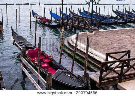 Venice / Italy 19 February 2019 :gondols ,the Symbol Of Venice , Parked In The Canal