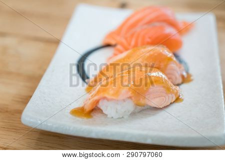 Close Up Salmon Burned Top With Mayo In Plate. Healthy Japanese Nigiri Aburi Sushi Style With Rice A