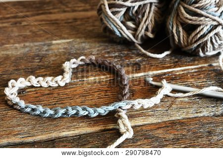 A Close Up Image Of A Single Crochet Hook And Crochet Yarn In A Heart Shaped Symbol With A Pair Of R