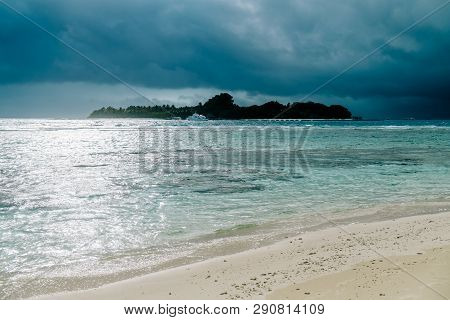 Maldives Background. Sunset Over The Tropical Sea And Coral Beach With Colorful Clouds In The Sky. B